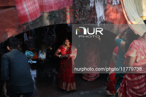 Hindu people participate in floating decorated boats made with banana stems as people gather to take a holy dip in the river Ganges on the o...