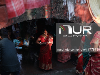 Hindu people participate in floating decorated boats made with banana stems as people gather to take a holy dip in the river Ganges on the o...