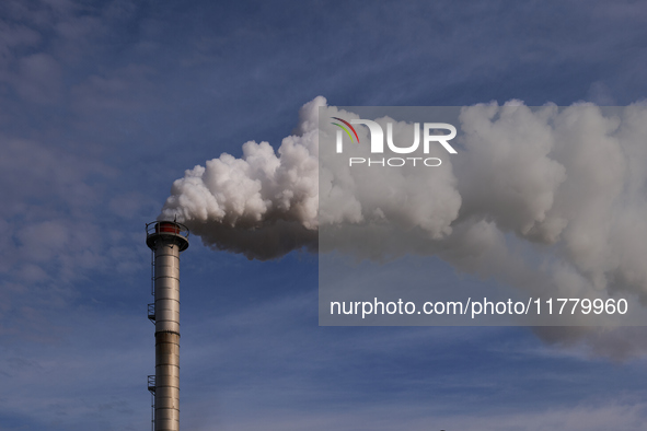 This image shows the smoking chimney of an industrial plant in Andria, Italy, on March 3, 2023. The billowing smoke highlights the environme...