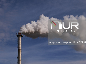 This image shows the smoking chimney of an industrial plant in Andria, Italy, on March 3, 2023. The billowing smoke highlights the environme...