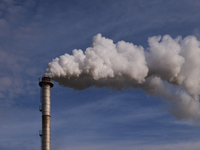 This image shows the smoking chimney of an industrial plant in Andria, Italy, on March 3, 2023. The billowing smoke highlights the environme...