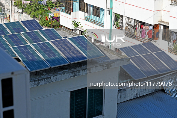 Solar energy panels are seen on the rooftops of a high-rise residential building in Dhaka, Bangladesh, on November 15, 2024. The building au...