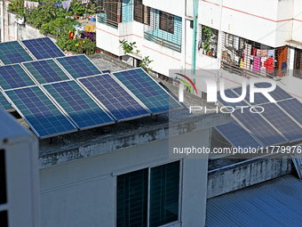 Solar energy panels are seen on the rooftops of a high-rise residential building in Dhaka, Bangladesh, on November 15, 2024. The building au...