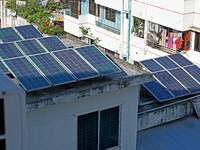 Solar energy panels are seen on the rooftops of a high-rise residential building in Dhaka, Bangladesh, on November 15, 2024. The building au...