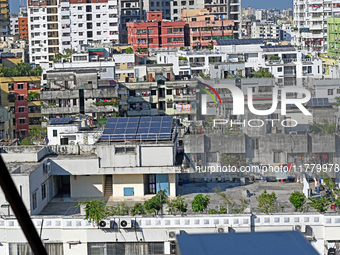 Solar energy panels are seen on the rooftops of a high-rise residential building in Dhaka, Bangladesh, on November 15, 2024. The building au...