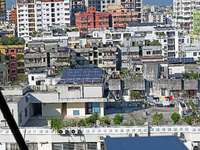 Solar energy panels are seen on the rooftops of a high-rise residential building in Dhaka, Bangladesh, on November 15, 2024. The building au...