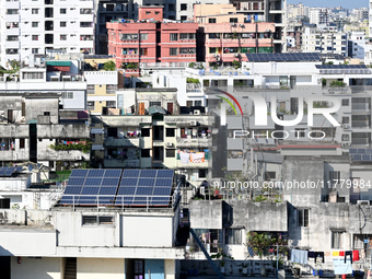 Solar energy panels are seen on the rooftops of a high-rise residential building in Dhaka, Bangladesh, on November 15, 2024. The building au...