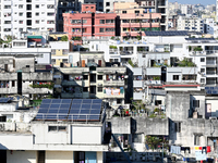 Solar energy panels are seen on the rooftops of a high-rise residential building in Dhaka, Bangladesh, on November 15, 2024. The building au...