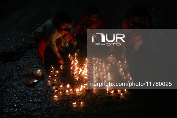 Hindu devotees light oil lamps on the banks of the river Ganges on the occasion of the Hindu religious festival of Dev Deepawali in Kolkata,...