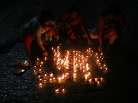 Hindu devotees light oil lamps on the banks of the river Ganges on the occasion of the Hindu religious festival of Dev Deepawali in Kolkata,...