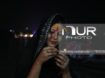 Hindu devotees light oil lamps on the banks of the river Ganges on the occasion of the Hindu religious festival of Dev Deepawali in Kolkata,...