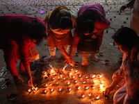 Hindu devotees light oil lamps on the banks of the river Ganges on the occasion of the Hindu religious festival of Dev Deepawali in Kolkata,...