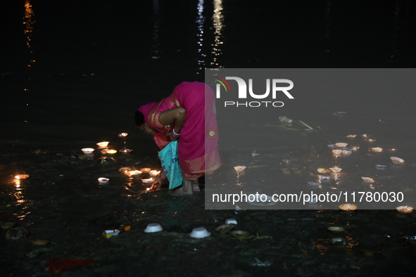 Hindu devotees light oil lamps on the banks of the river Ganges on the occasion of the Hindu religious festival of Dev Deepawali in Kolkata,...