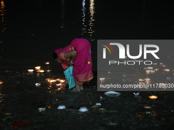 Hindu devotees light oil lamps on the banks of the river Ganges on the occasion of the Hindu religious festival of Dev Deepawali in Kolkata,...