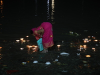 Hindu devotees light oil lamps on the banks of the river Ganges on the occasion of the Hindu religious festival of Dev Deepawali in Kolkata,...