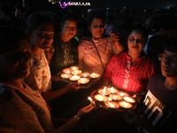 Hindu devotees light oil lamps on the banks of the river Ganges on the occasion of the Hindu religious festival of Dev Deepawali in Kolkata,...