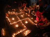 Hindu devotees light oil lamps on the banks of the river Ganges on the occasion of the Hindu religious festival of Dev Deepawali in Kolkata,...