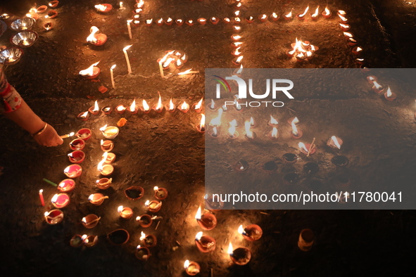 Hindu devotees light oil lamps on the banks of the river Ganges on the occasion of the Hindu religious festival of Dev Deepawali in Kolkata,...