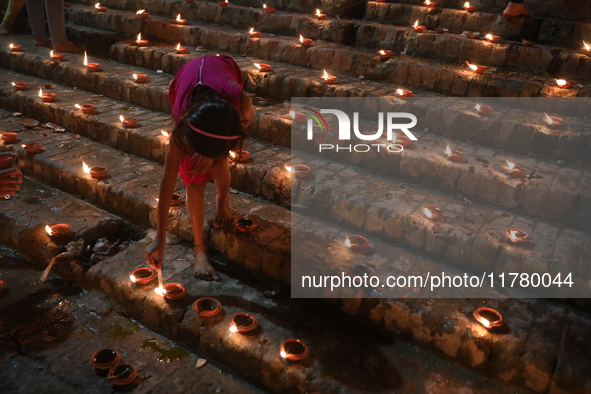 Hindu devotees light oil lamps on the banks of the river Ganges on the occasion of the Hindu religious festival of Dev Deepawali in Kolkata,...