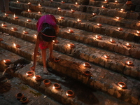 Hindu devotees light oil lamps on the banks of the river Ganges on the occasion of the Hindu religious festival of Dev Deepawali in Kolkata,...