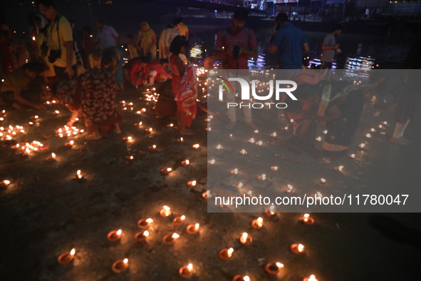 Hindu devotees light oil lamps on the banks of the river Ganges on the occasion of the Hindu religious festival of Dev Deepawali in Kolkata,...