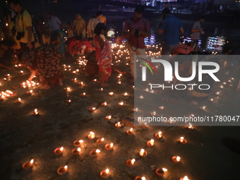 Hindu devotees light oil lamps on the banks of the river Ganges on the occasion of the Hindu religious festival of Dev Deepawali in Kolkata,...