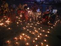 Hindu devotees light oil lamps on the banks of the river Ganges on the occasion of the Hindu religious festival of Dev Deepawali in Kolkata,...