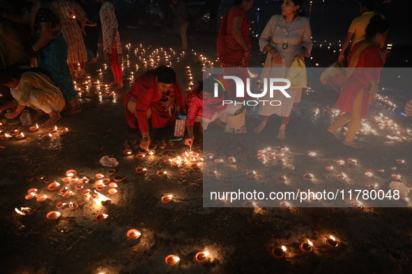 Hindu devotees light oil lamps on the banks of the river Ganges on the occasion of the Hindu religious festival of Dev Deepawali in Kolkata,...