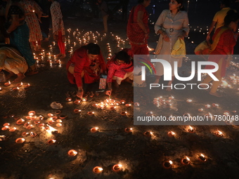 Hindu devotees light oil lamps on the banks of the river Ganges on the occasion of the Hindu religious festival of Dev Deepawali in Kolkata,...