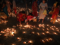 Hindu devotees light oil lamps on the banks of the river Ganges on the occasion of the Hindu religious festival of Dev Deepawali in Kolkata,...