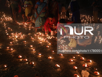 Hindu devotees light oil lamps on the banks of the river Ganges on the occasion of the Hindu religious festival of Dev Deepawali in Kolkata,...