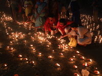 Hindu devotees light oil lamps on the banks of the river Ganges on the occasion of the Hindu religious festival of Dev Deepawali in Kolkata,...