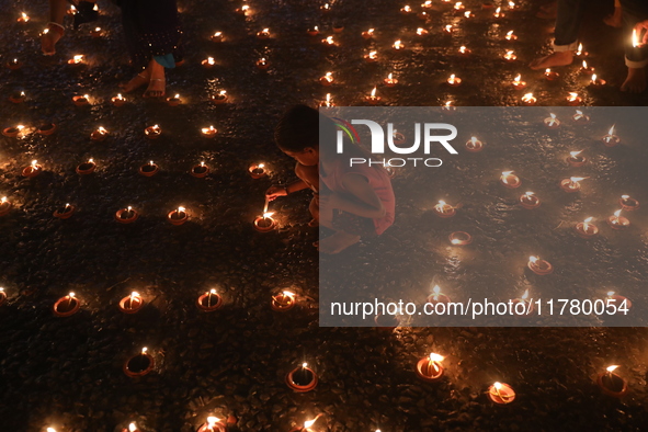 Hindu devotees light oil lamps on the banks of the river Ganges on the occasion of the Hindu religious festival of Dev Deepawali in Kolkata,...