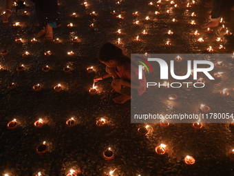 Hindu devotees light oil lamps on the banks of the river Ganges on the occasion of the Hindu religious festival of Dev Deepawali in Kolkata,...