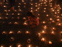 Hindu devotees light oil lamps on the banks of the river Ganges on the occasion of the Hindu religious festival of Dev Deepawali in Kolkata,...