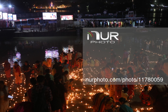 Hindu devotees light oil lamps on the banks of the river Ganges on the occasion of the Hindu religious festival of Dev Deepawali in Kolkata,...