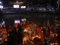 Hindu devotees light oil lamps on the banks of the river Ganges on the occasion of the Hindu religious festival of Dev Deepawali in Kolkata,...