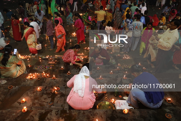 Hindu devotees light oil lamps on the banks of the river Ganges on the occasion of the Hindu religious festival of Dev Deepawali in Kolkata,...