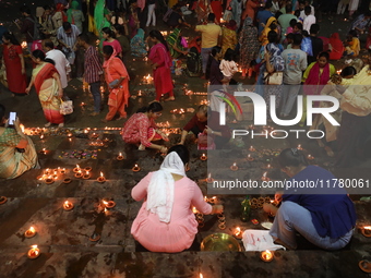 Hindu devotees light oil lamps on the banks of the river Ganges on the occasion of the Hindu religious festival of Dev Deepawali in Kolkata,...