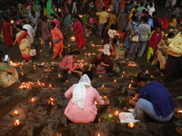 Hindu devotees light oil lamps on the banks of the river Ganges on the occasion of the Hindu religious festival of Dev Deepawali in Kolkata,...