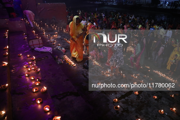 Hindu devotees light oil lamps on the banks of the river Ganges on the occasion of the Hindu religious festival of Dev Deepawali in Kolkata,...