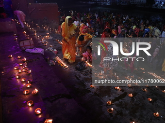 Hindu devotees light oil lamps on the banks of the river Ganges on the occasion of the Hindu religious festival of Dev Deepawali in Kolkata,...