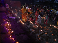 Hindu devotees light oil lamps on the banks of the river Ganges on the occasion of the Hindu religious festival of Dev Deepawali in Kolkata,...