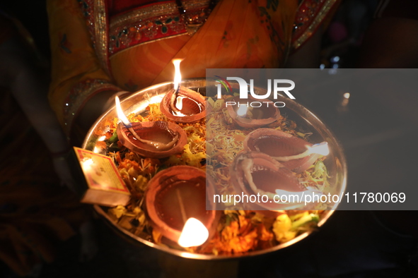 Hindu devotees light oil lamps on the banks of the river Ganges on the occasion of the Hindu religious festival of Dev Deepawali in Kolkata,...