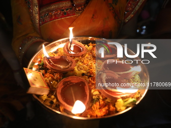 Hindu devotees light oil lamps on the banks of the river Ganges on the occasion of the Hindu religious festival of Dev Deepawali in Kolkata,...