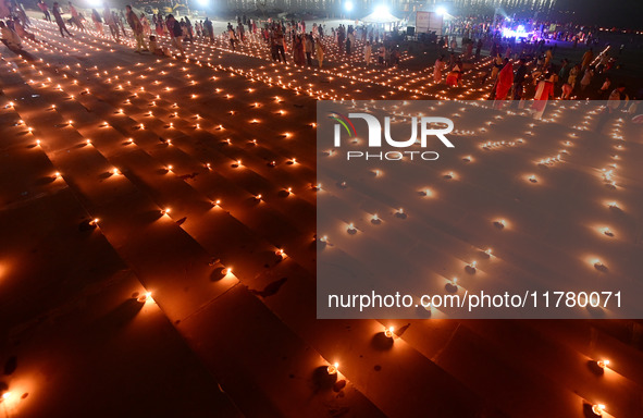 Devotees light traditional oil lamps as they celebrate the Hindu festival of 'Dev Deepawali' at Sangam, the confluence of the rivers Ganges,...