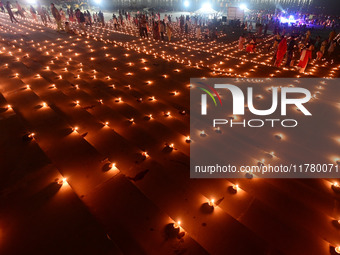 Devotees light traditional oil lamps as they celebrate the Hindu festival of 'Dev Deepawali' at Sangam, the confluence of the rivers Ganges,...