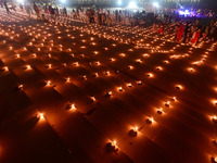 Devotees light traditional oil lamps as they celebrate the Hindu festival of 'Dev Deepawali' at Sangam, the confluence of the rivers Ganges,...