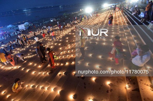 Devotees light traditional oil lamps as they celebrate the Hindu festival of 'Dev Deepawali' at Sangam, the confluence of the rivers Ganges,...