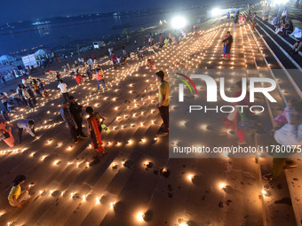 Devotees light traditional oil lamps as they celebrate the Hindu festival of 'Dev Deepawali' at Sangam, the confluence of the rivers Ganges,...